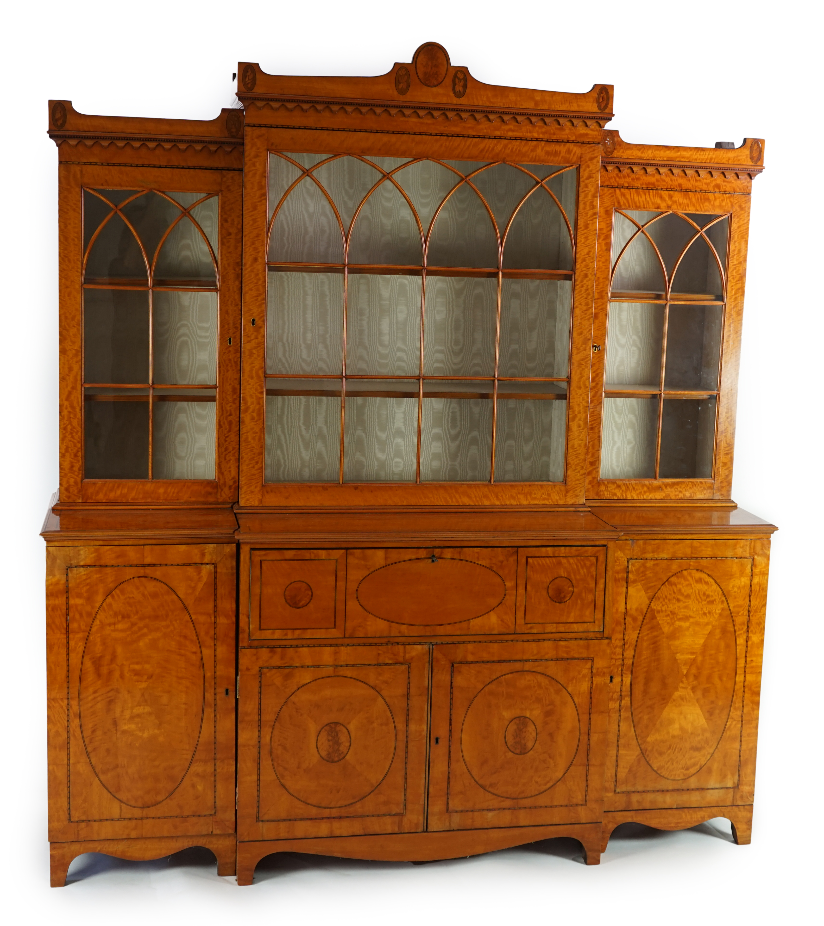 A Sheraton revival ebony strung satinwood breakfront secretaire bookcase